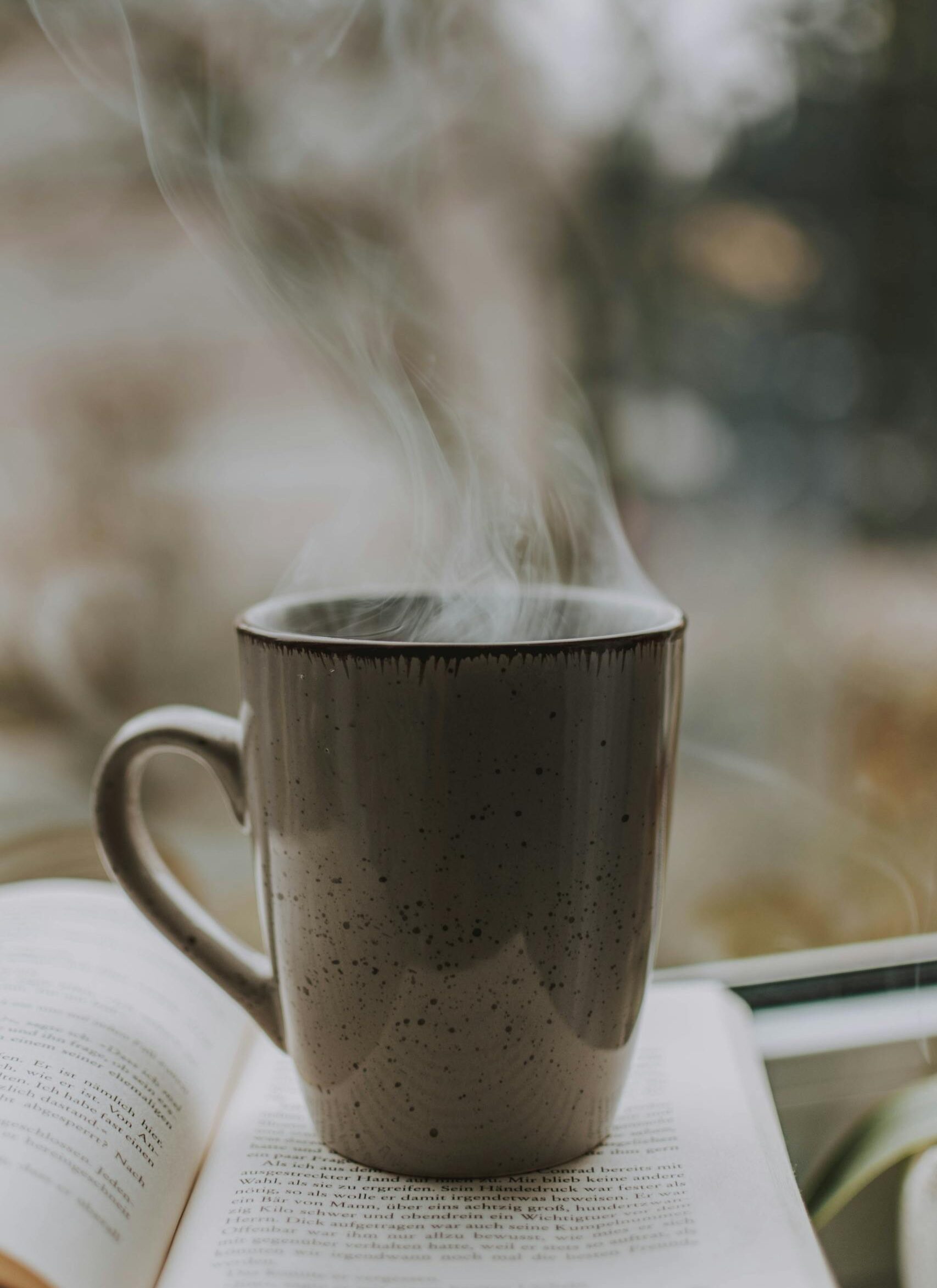 Photo of Coffee Mug on Top of Book